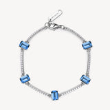 Bracciale semirigido in argento rodiato 925‰ con cubic zirconia chiari e baguette cubic zirconia colore sapphire.