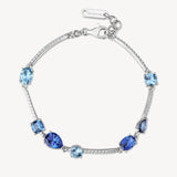 Bracciale semirigido in argento rodiato 925‰ con cubic zirconia chiari e cubic zirconia colore sapphire. Lunghezza bracciale 18cm.