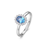 Anello kate in argento rodiato 925‰ con oval cubic zirconia chiari e colore sapphire. Misura 14.