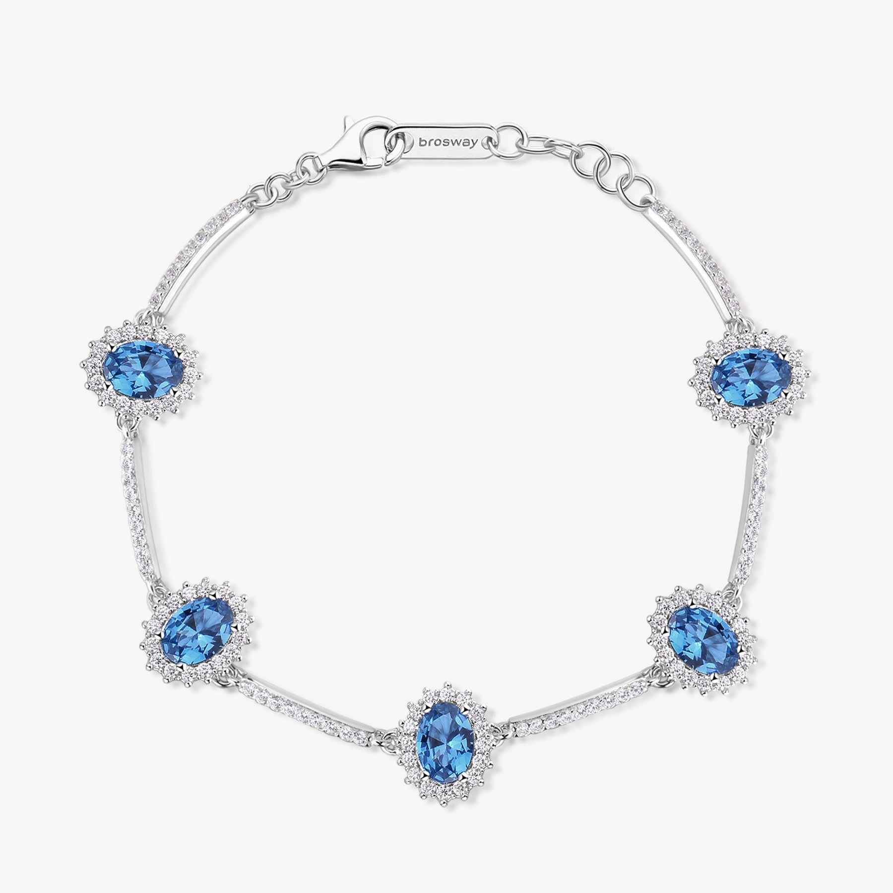 Bracciale Kate semirigido in argento rodiato 925‰ con oval cubic zirconia chiari e colore sapphire. Lunghezza 18cm.