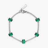 Bracciale semirigido in argento rodiato 925‰ con cubic zirconia chiari e baguette cubic zirconia colore emerald. Lunghezza bracciale 18cm.